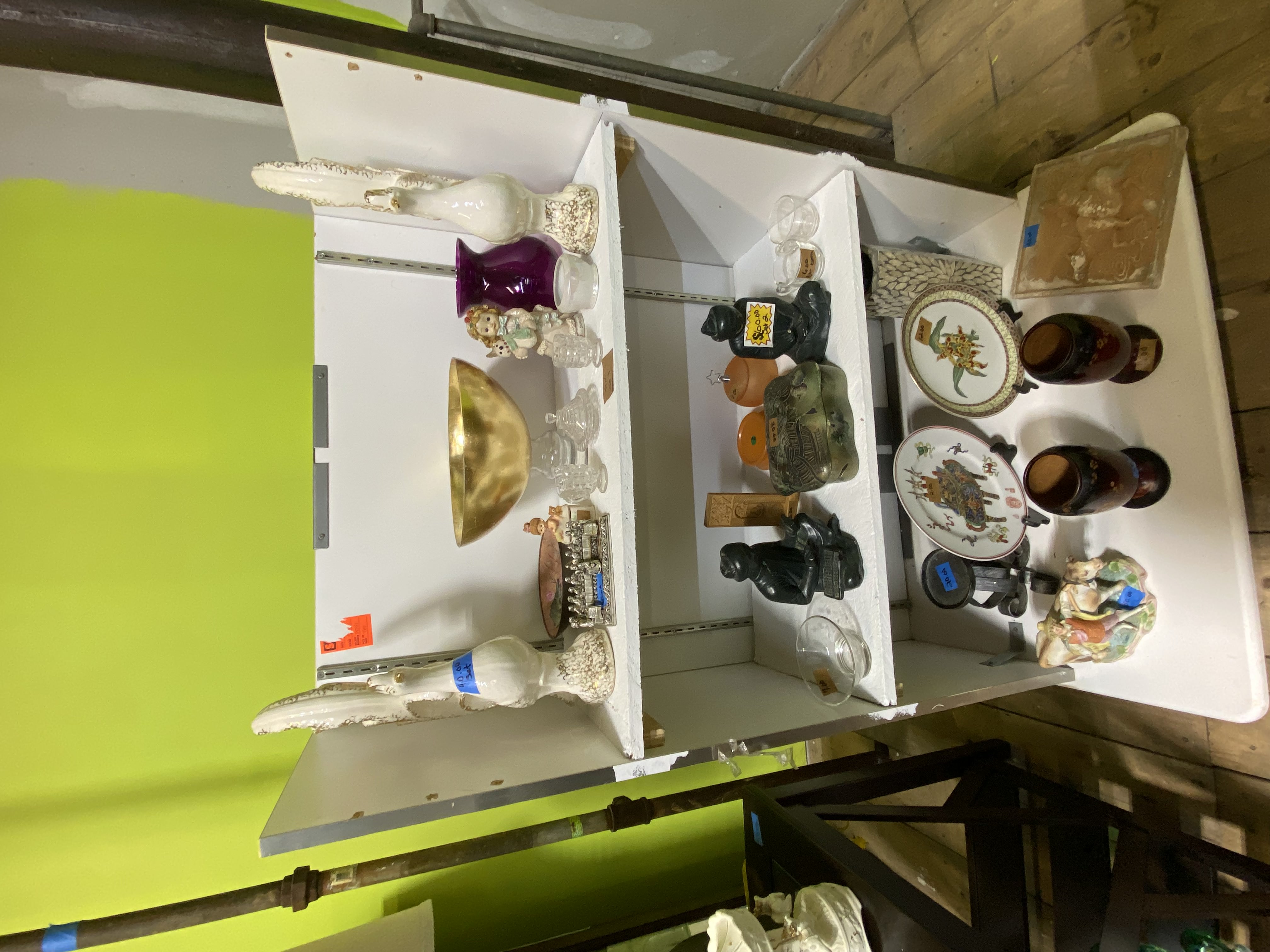 Home décor items including artwork and decorations in thrift store