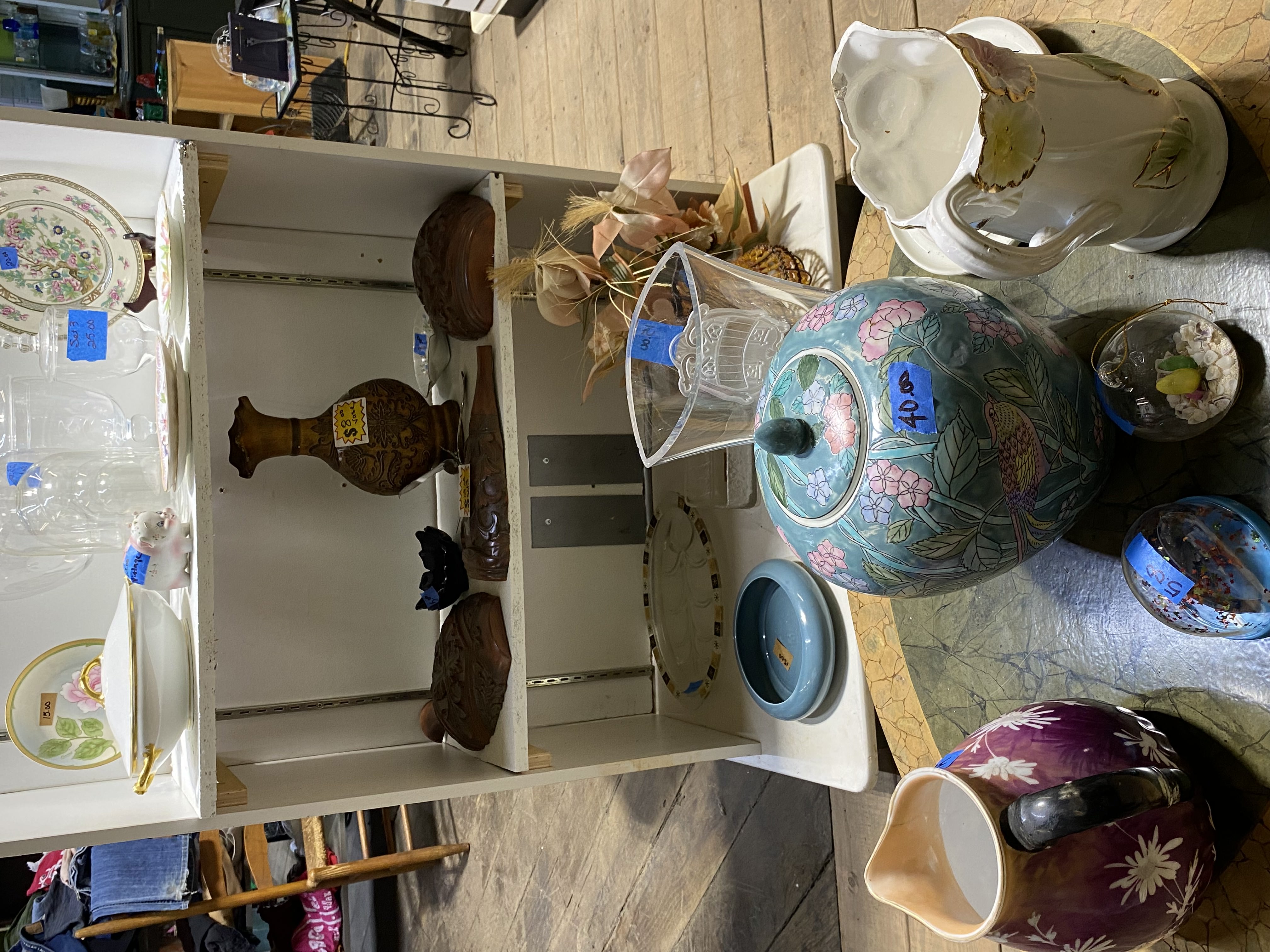 Home décor items including artwork and decorations in thrift store